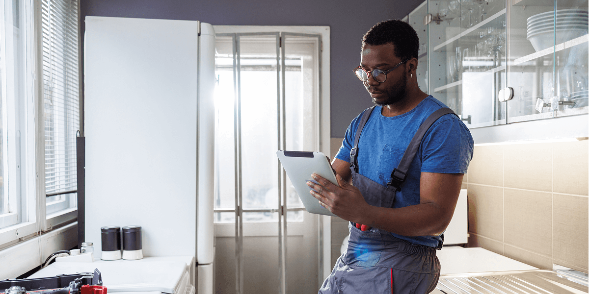 Man using tablet in modern kitchen