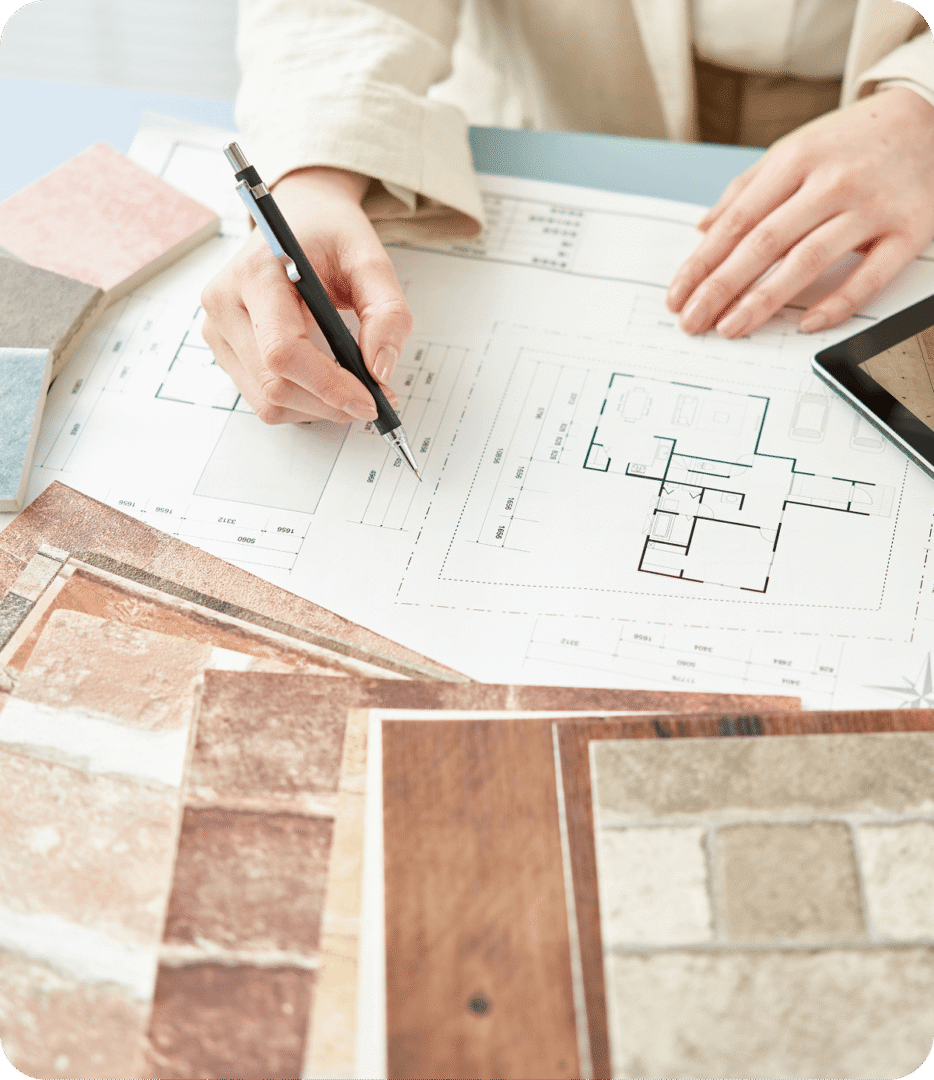 Hands sketching on floor plan layout