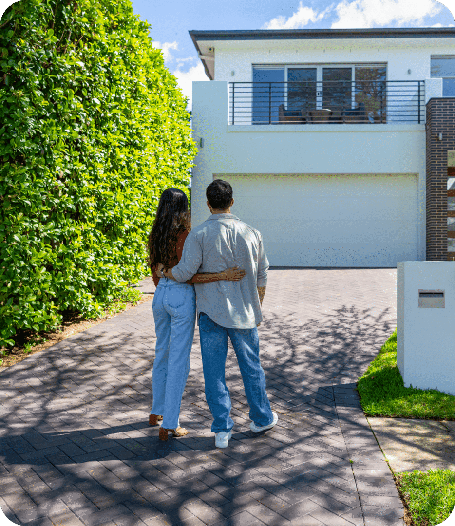 Pair standing on driveway facing house