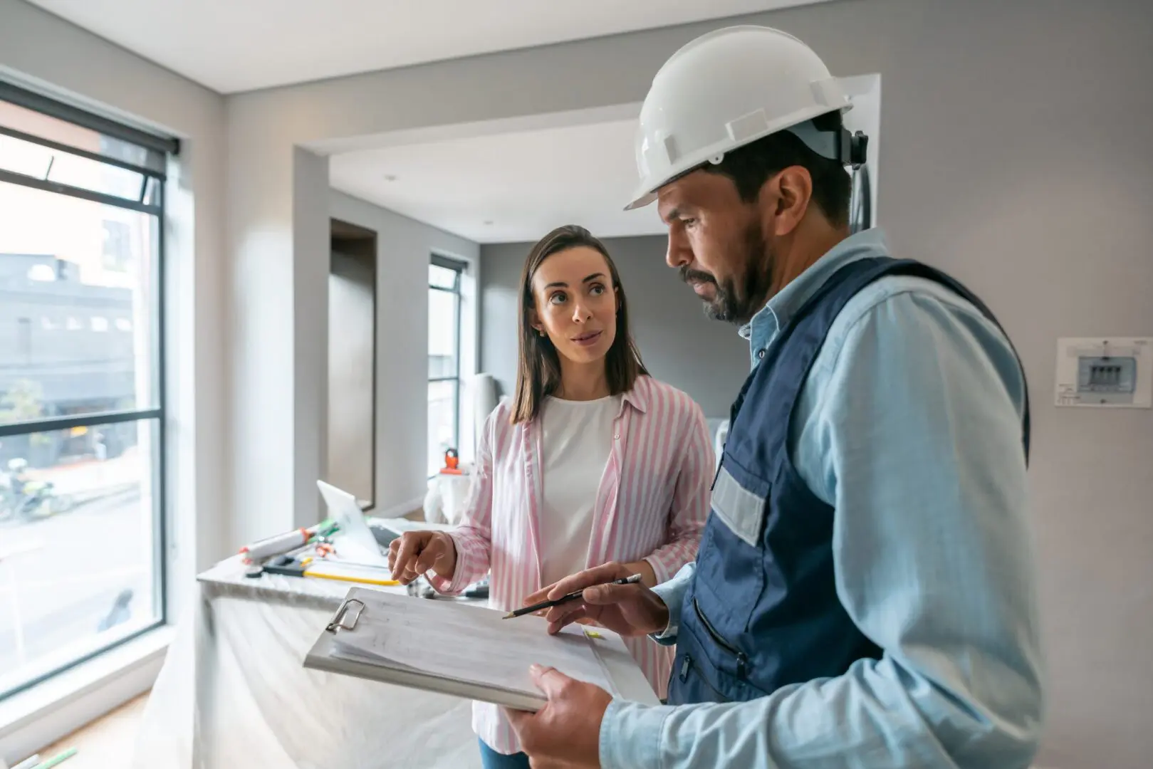 Contractor and client reviewing interior renovation plans