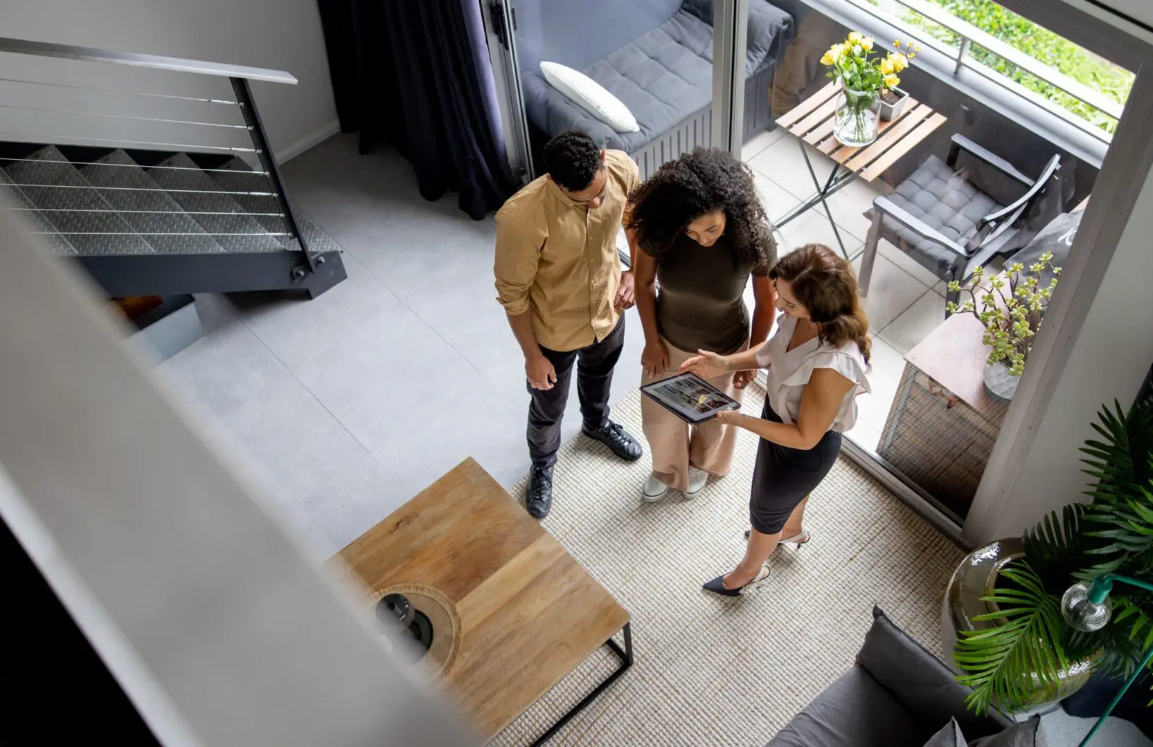 Real estate agent showing modern apartment to couple
